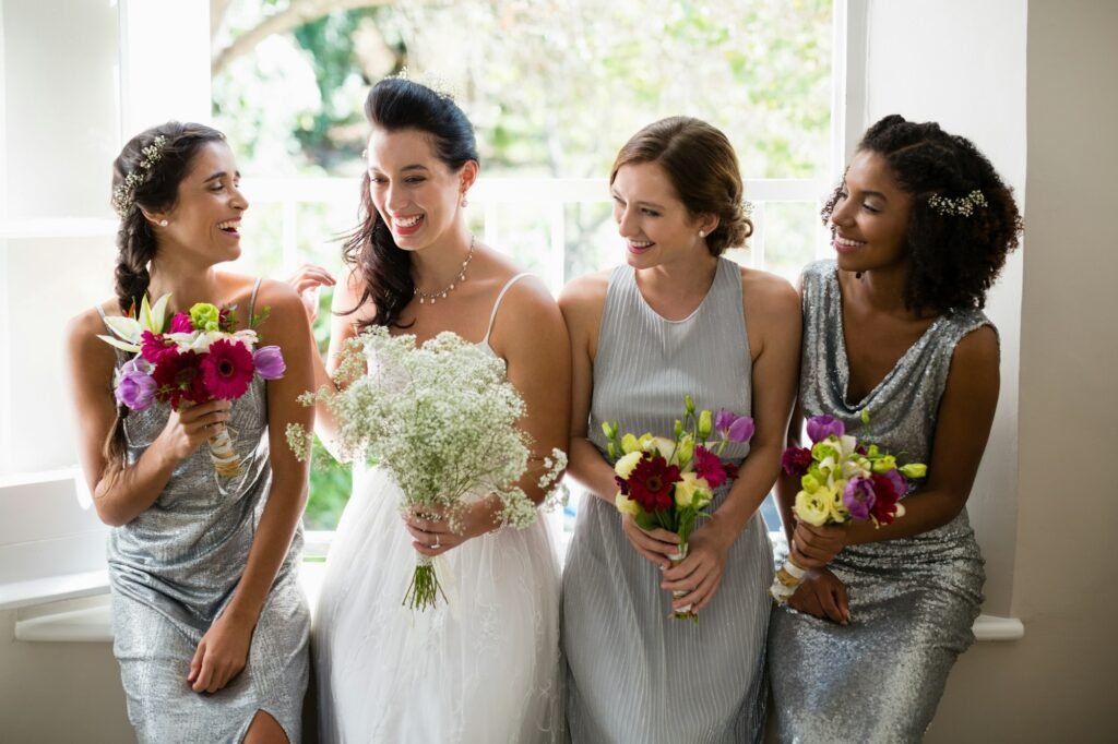 Bride and bridesmaids standing with bouquet